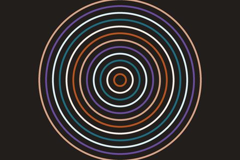Concentric rings in sand, terracotta, white, teal and violet, thickest at the outside and shrinking to a small centre, on a near-black background.